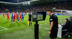 How Technology Is Changing Football Refereeing Systems 1 Football Referee Using VAR Technology During Live Match Decision